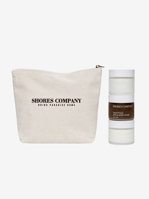A beige canvas zip pouch and a frosted cosmetic stick container from Shores Company, both printed with the brand name, on a light gray background.