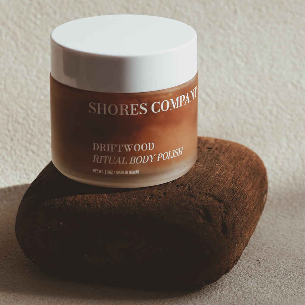 Jar of Shores Company Driftwood Ritual Body Polish on a textured surface with a neutral background