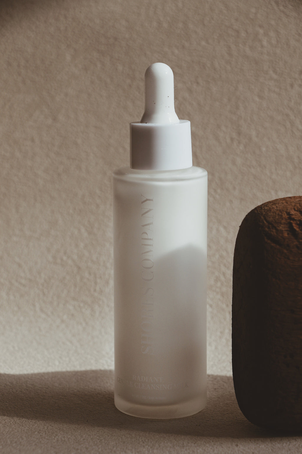 Skincare dropper bottle with a textured background