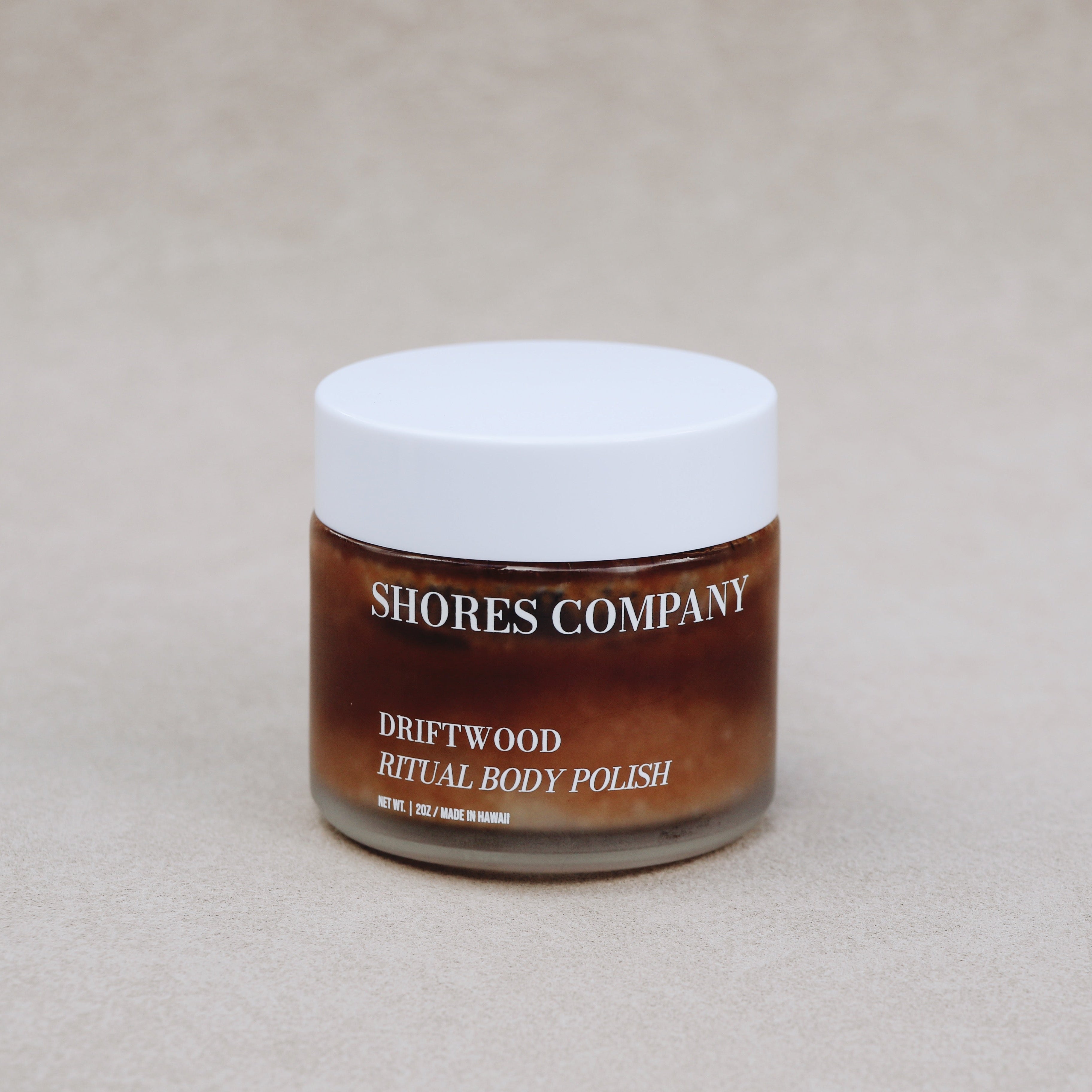 Jar of Shores Company Driftwood Ritual Body Polish on a beige background