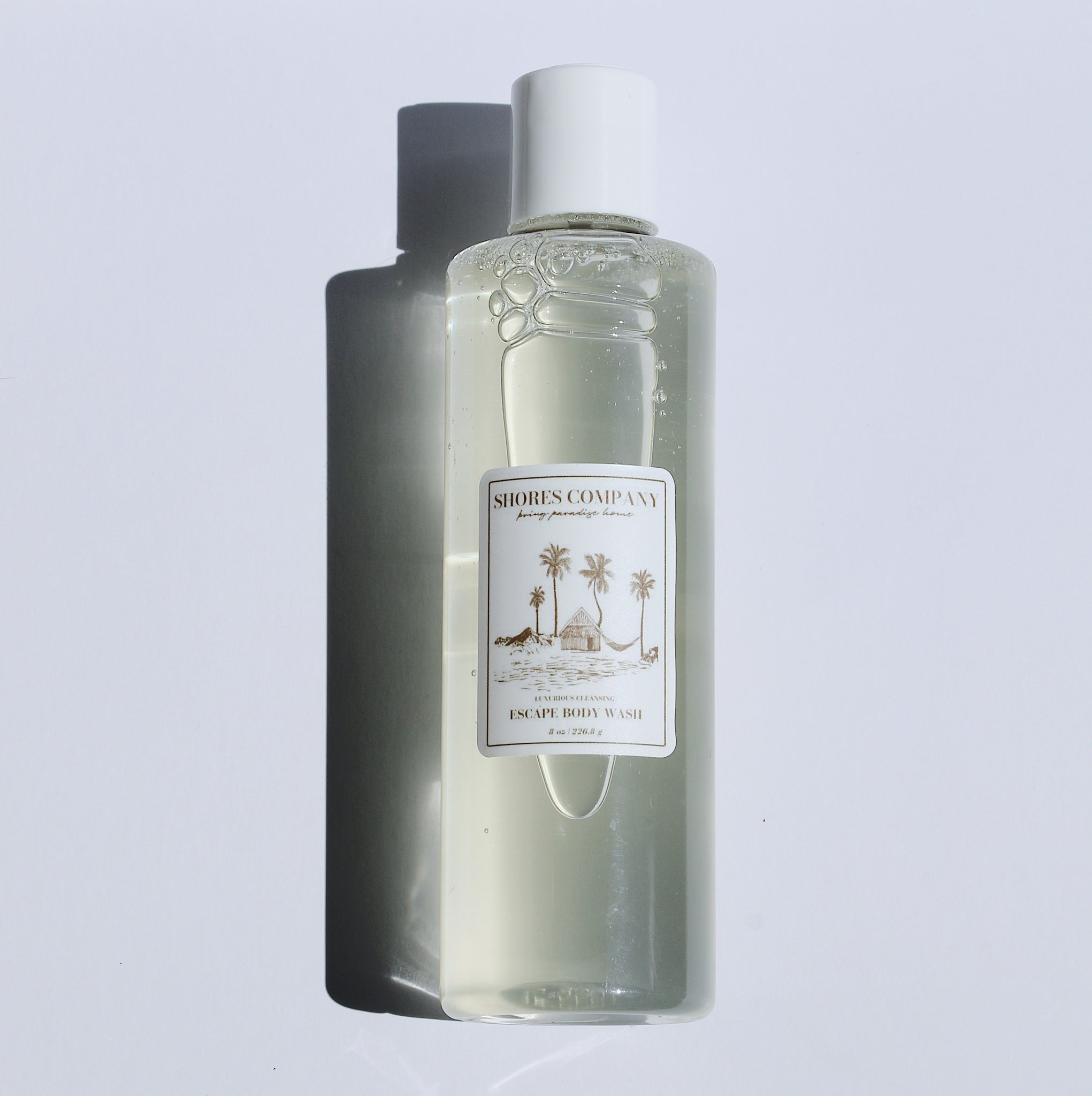 Escape Body Wash by Shores Company – luxurious, island-inspired body wash infused with natural botanicals and ocean minerals, crafted in Hawaii for a refreshing and nourishing cleanse.