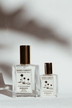 Two perfume bottles from Shores Company on a light background