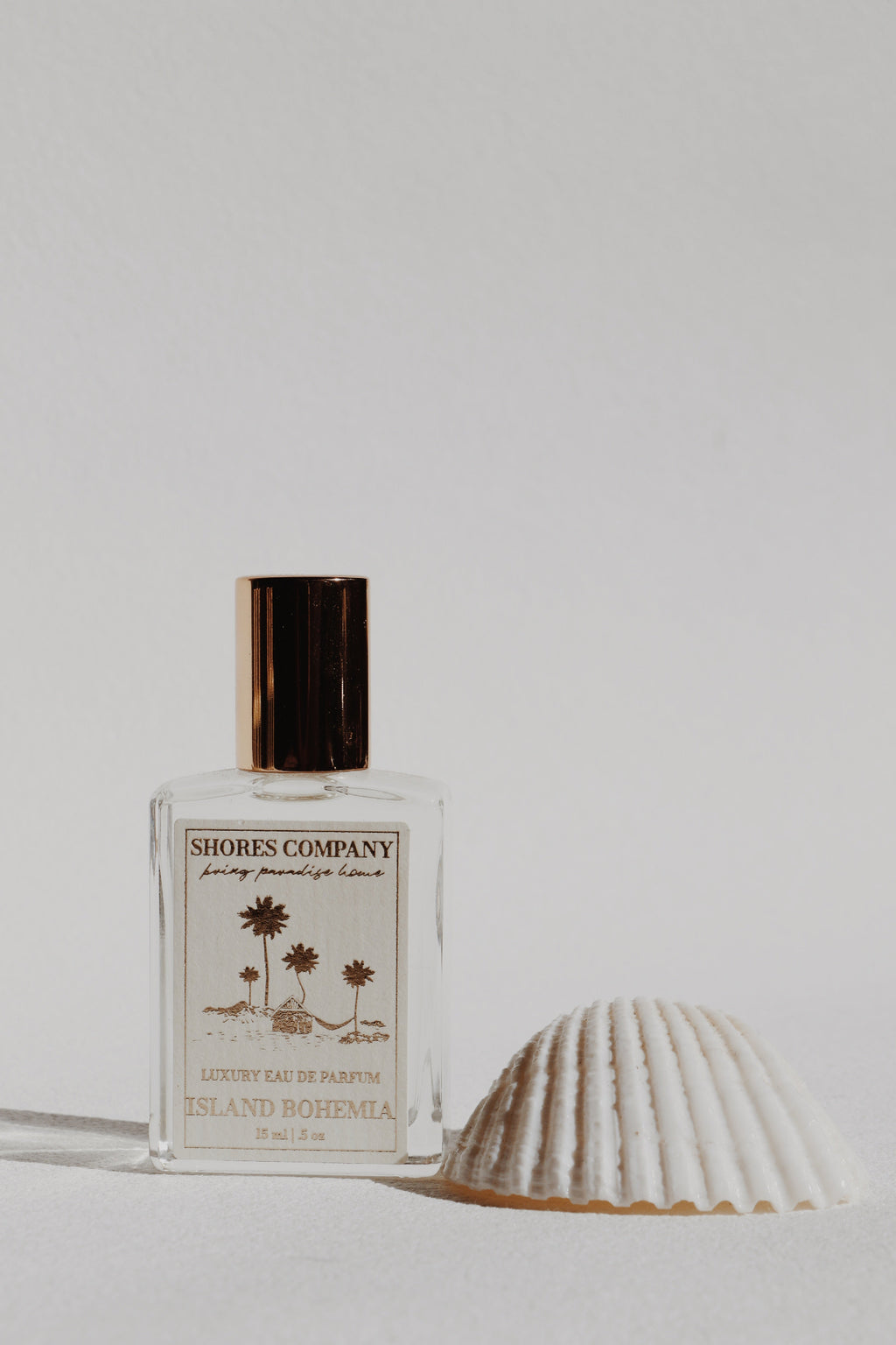 Shores Company perfume bottle with a shell on a light background