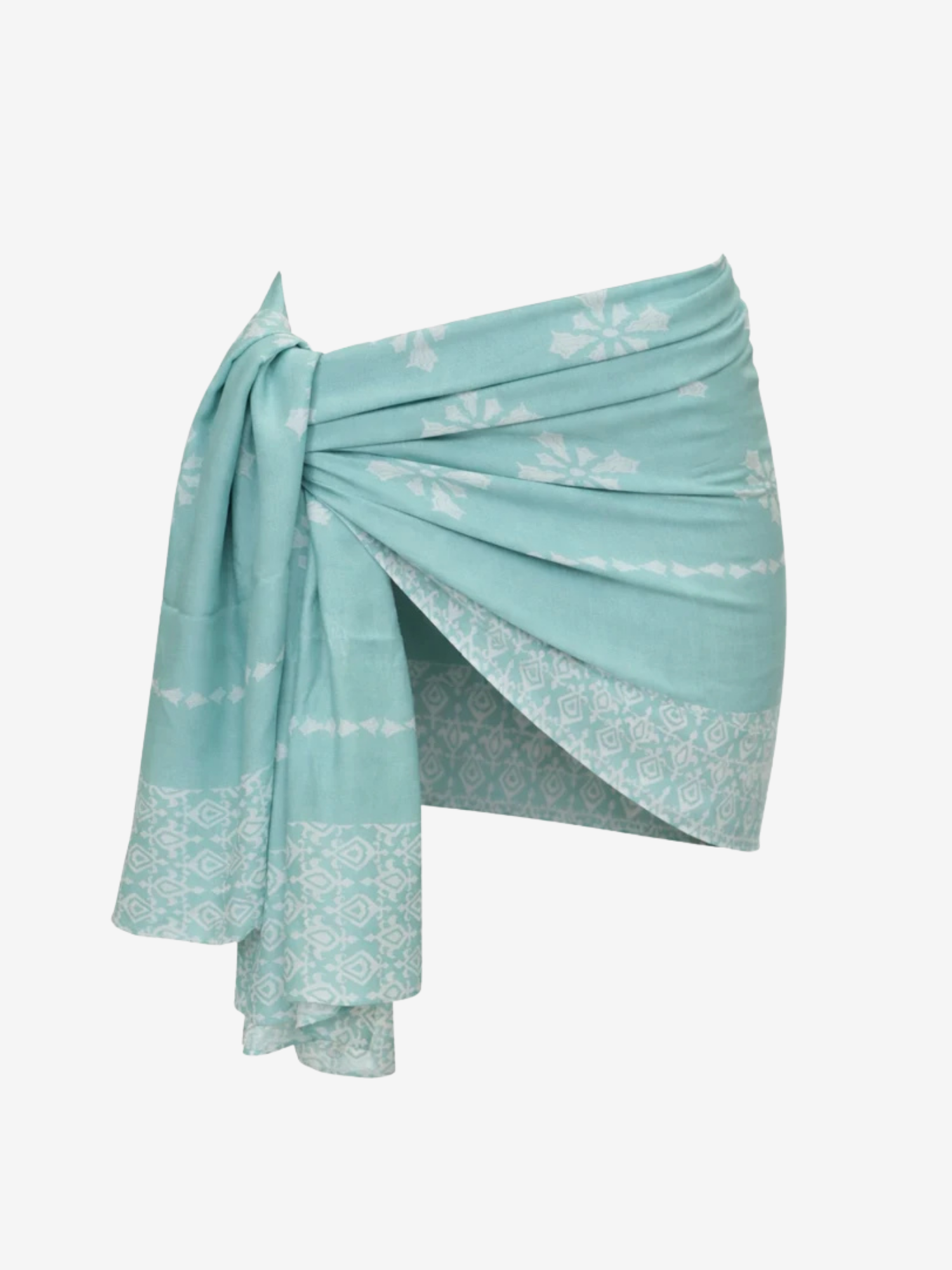 A light turquoise blue sarong wrap featuring white and shell geometric block prints, styled in a side-tie knot against a plain white background.