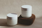 Two Shores Co Skin Care containers with lids on a textured surface