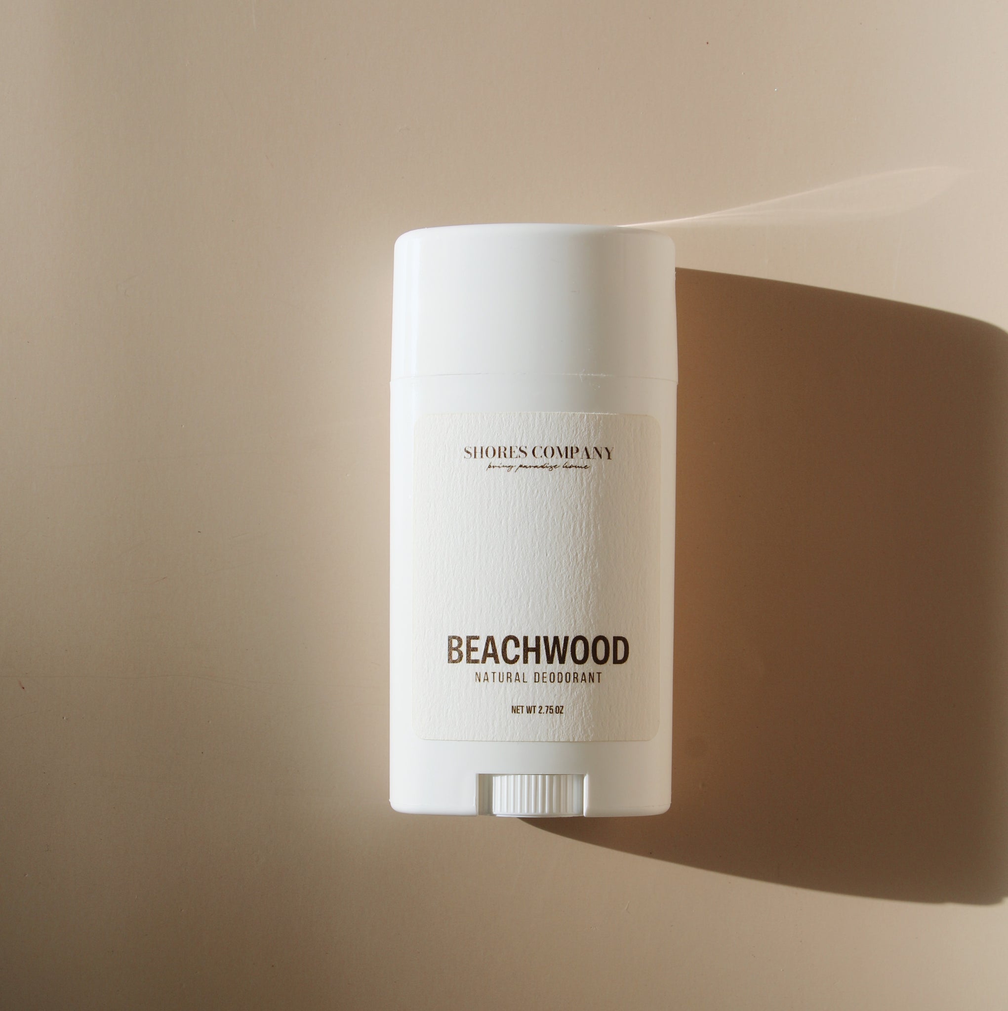 Shores Company Beachwood Natural Deodorant in a minimalist white tube with elegant branding on a neutral background.