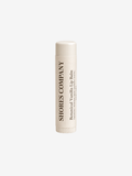 A single tube of Shores Company Botanical Vanilla Lip Balm, shown upright against a solid off-white background.
