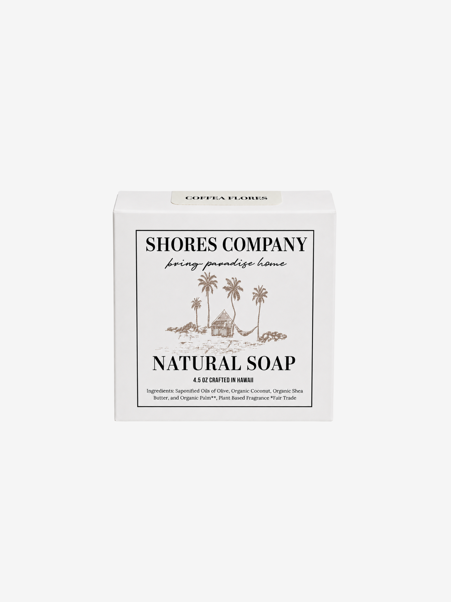 A white rectangular box of Shores Company Natural Soap, featuring a minimalist black and brown tropical illustration of palm trees and a hut on the front label.