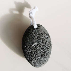 Eco-friendly black volcanic pumice stone from Shores Company, perfect for gentle and natural foot and body exfoliation.