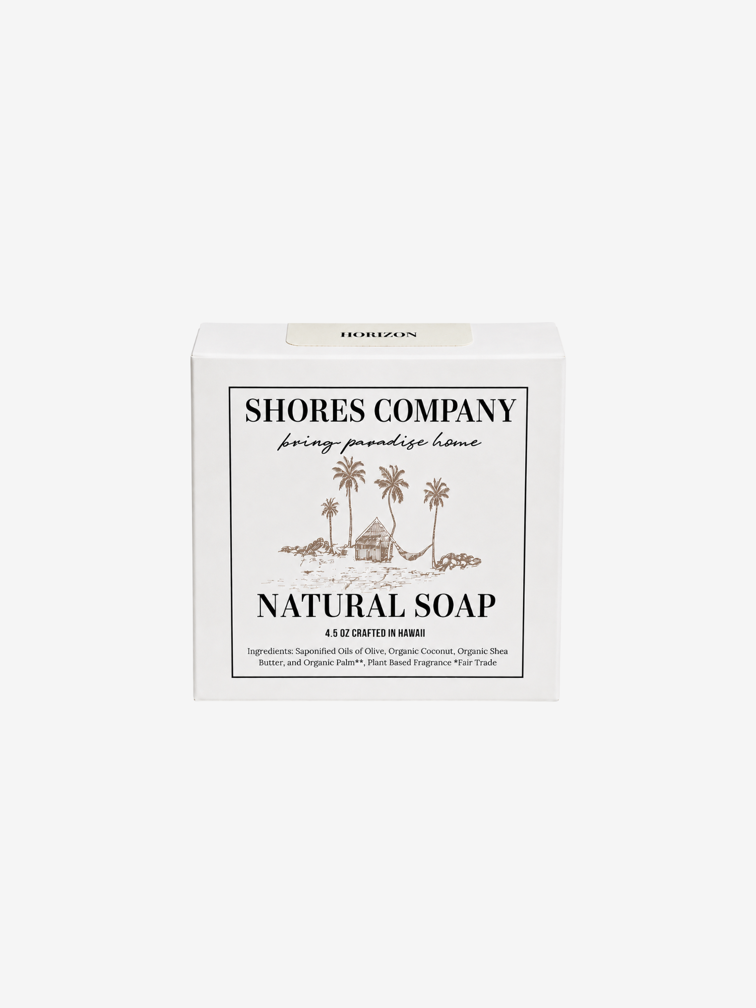 A white rectangular box of Shores Company Natural Soap with a tropical palm tree illustration and black text, centered on a light gray background.