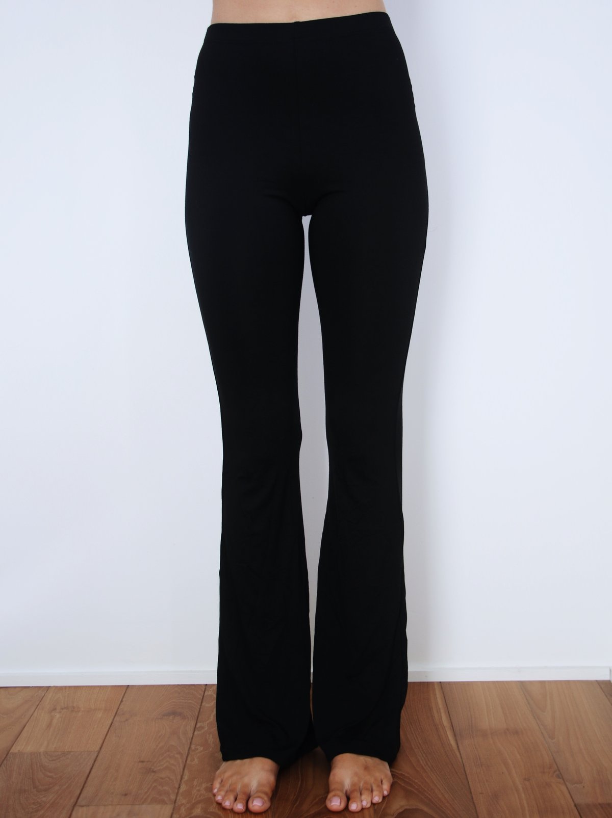 Front view of model wearing black Indah Lounge Pant – soft bamboo flare pant for everyday lounging or travel.