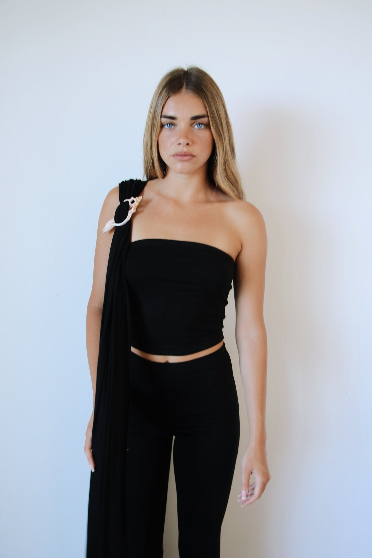 Model wearing Kirra Set in Abyss Black – bandeau top with shell wrap detail.