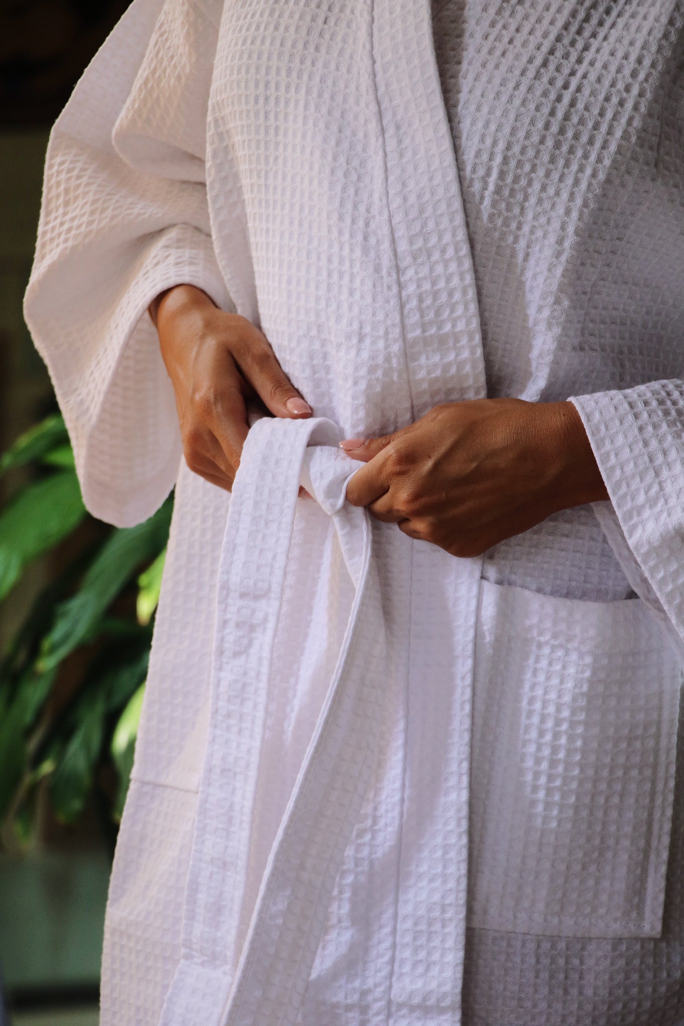 Close-up of the Noosa Bathrobe tie detail, showing the elegant white waffle texture and lightweight cotton fabric.