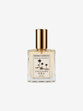 Shores Company Ora luxury eau de parfum in a square clear glass bottle with a gold cap and cream-colored label, set against a solid off-white background.