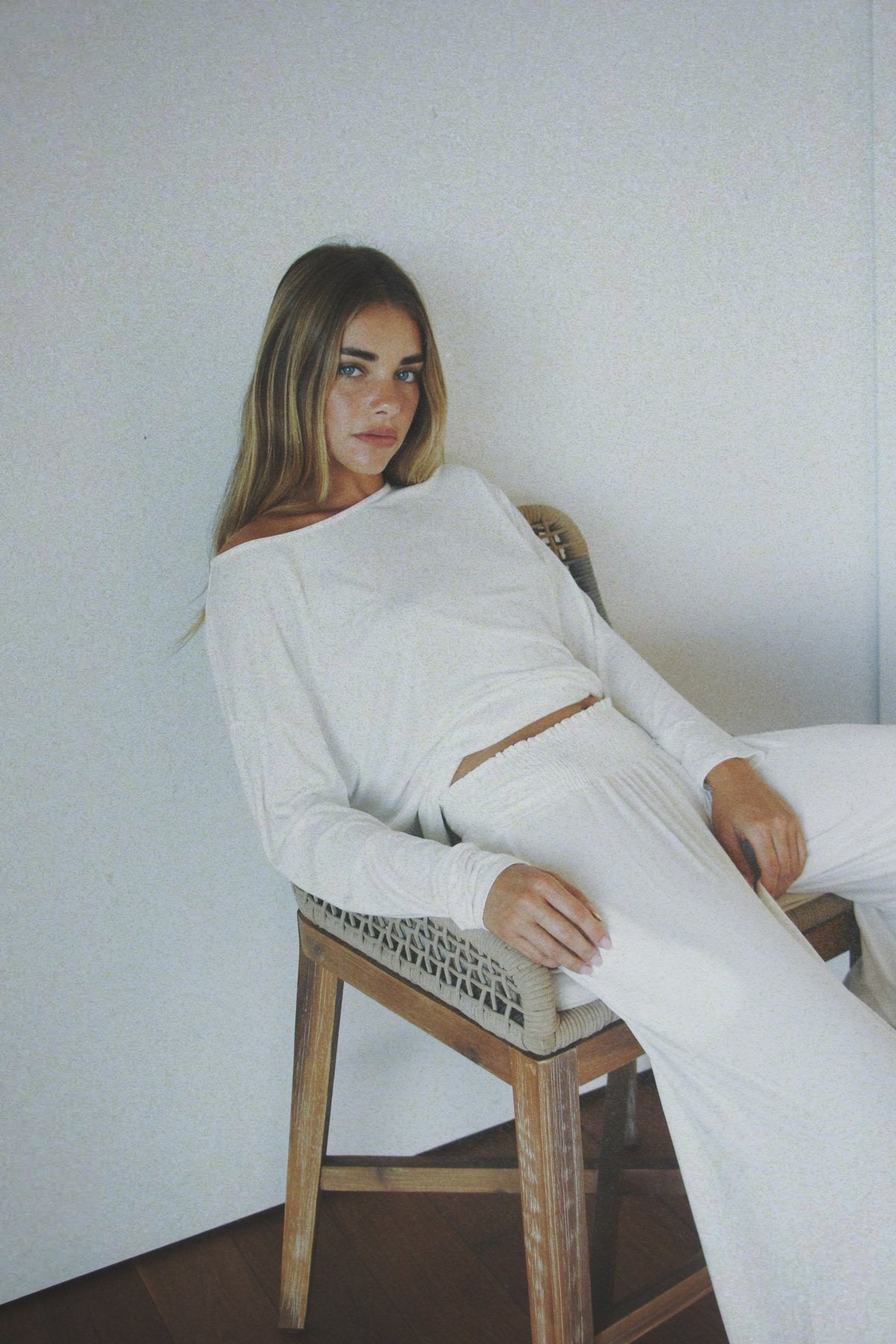 Model lounging in the Roamer Long Sleeve in white. The perfect island-inspired set for comfort and movement