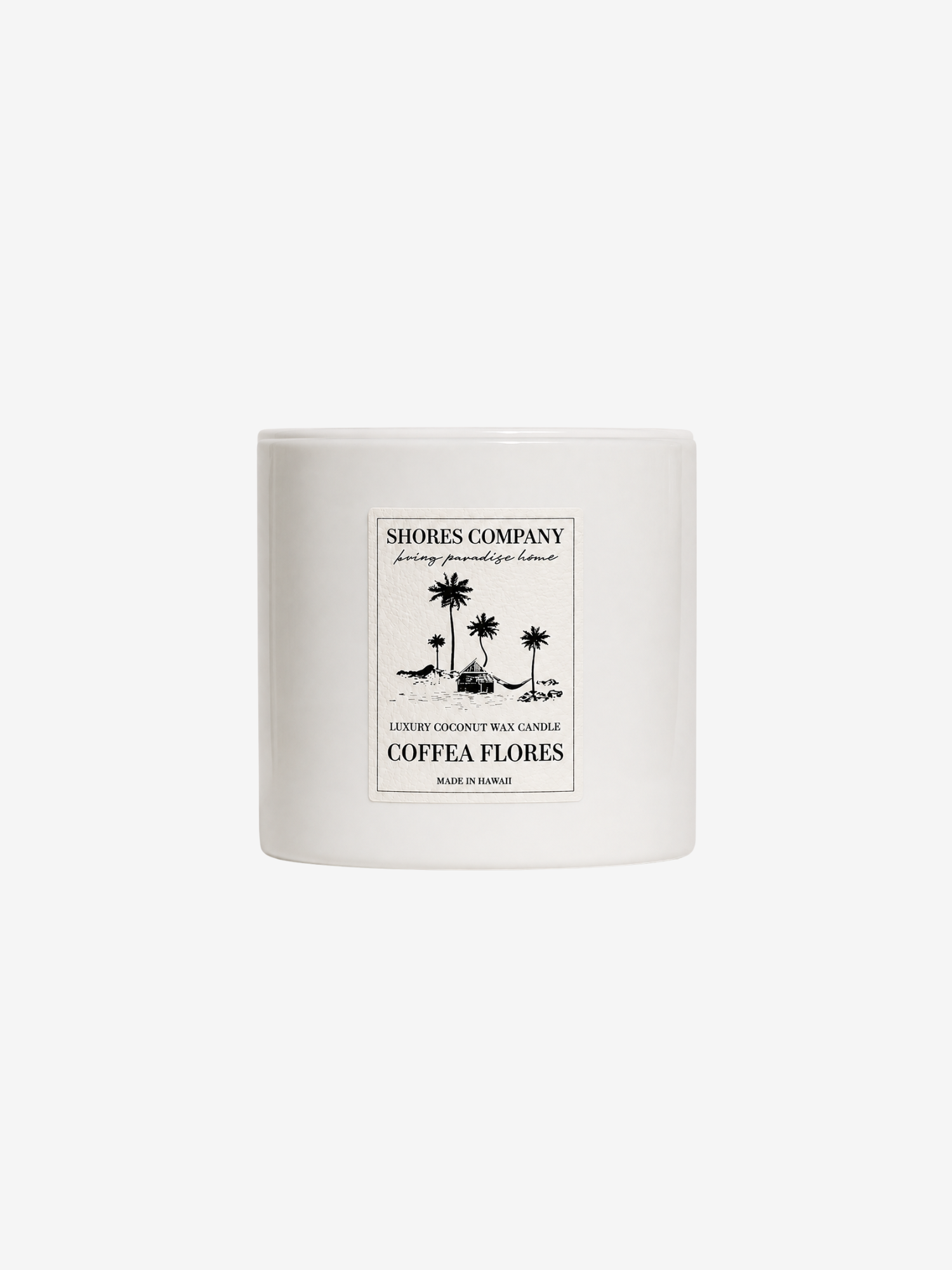 A white ceramic jar candle with a black printed label reading 'Shores Company' and 'Coffea Flores' with a palm tree illustration, centered on a light gray background.