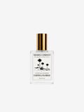 Shores Company Coeffe Flores perfume bottle with a gold cap and white label, centered on a light gray background.