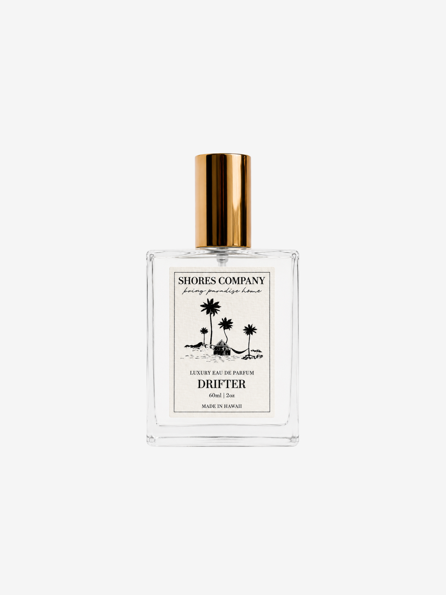 A clear glass perfume bottle with a metallic gold cap and a cream-colored label featuring black palm tree illustrations. The label reads 'SHORES COMPANY' and 'DRIFTER'.