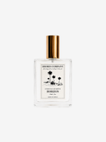 Shores Company Horizon luxury fragrance eau de parfum in a clear rectangular glass bottle with a gold cap and a cream-colored label featuring black palm tree illustrations, set against a solid light gray background.
