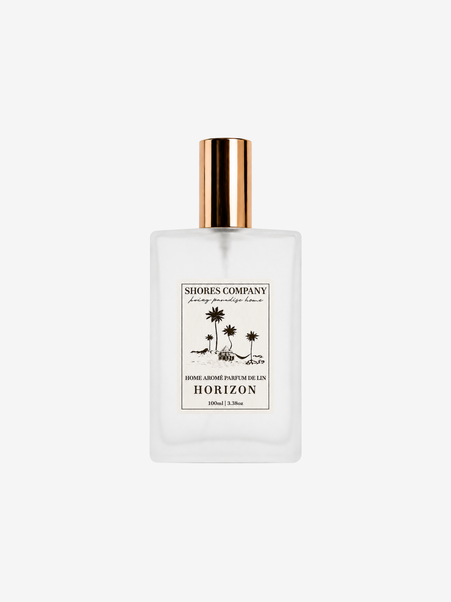 A frosted glass perfume bottle with a gold cap, featuring a white label with  text and palm tree illustrations. The brand 'Shores Company' is clearly visible on the label.
