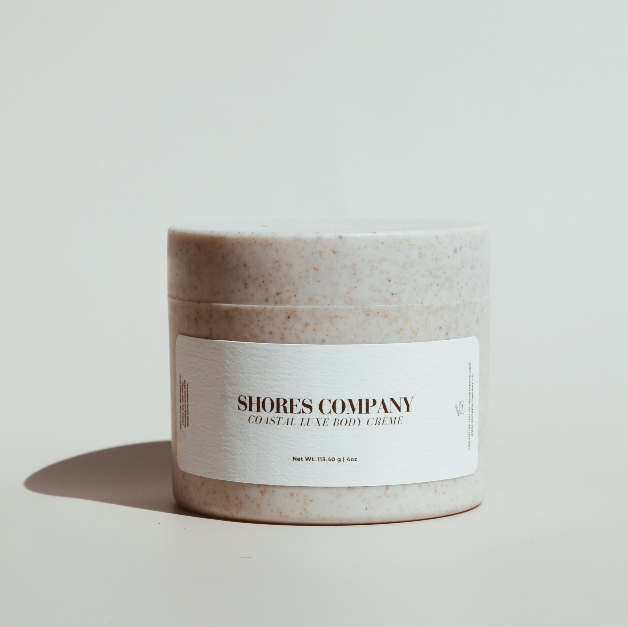 Shores Company Coastal Luxe Body Crème in an open jar, revealing its rich, velvety texture. A deeply hydrating body moisturizer infused with coconut oil and shea butter for soft, supple skin.