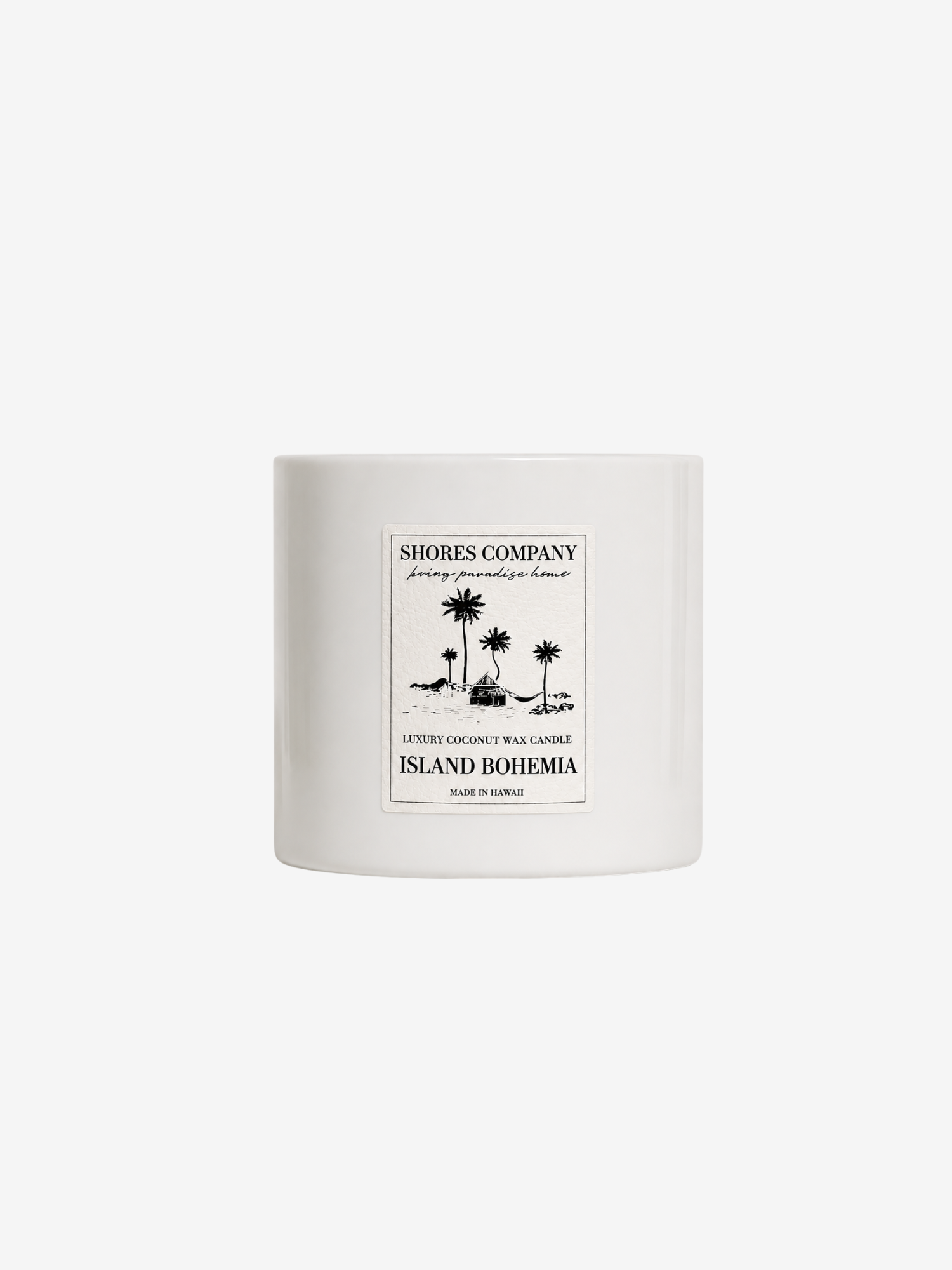 A white ceramic candle jar with a minimalist black label reading 'Shores Company' and 'Island Bohemia' on a plain white background.