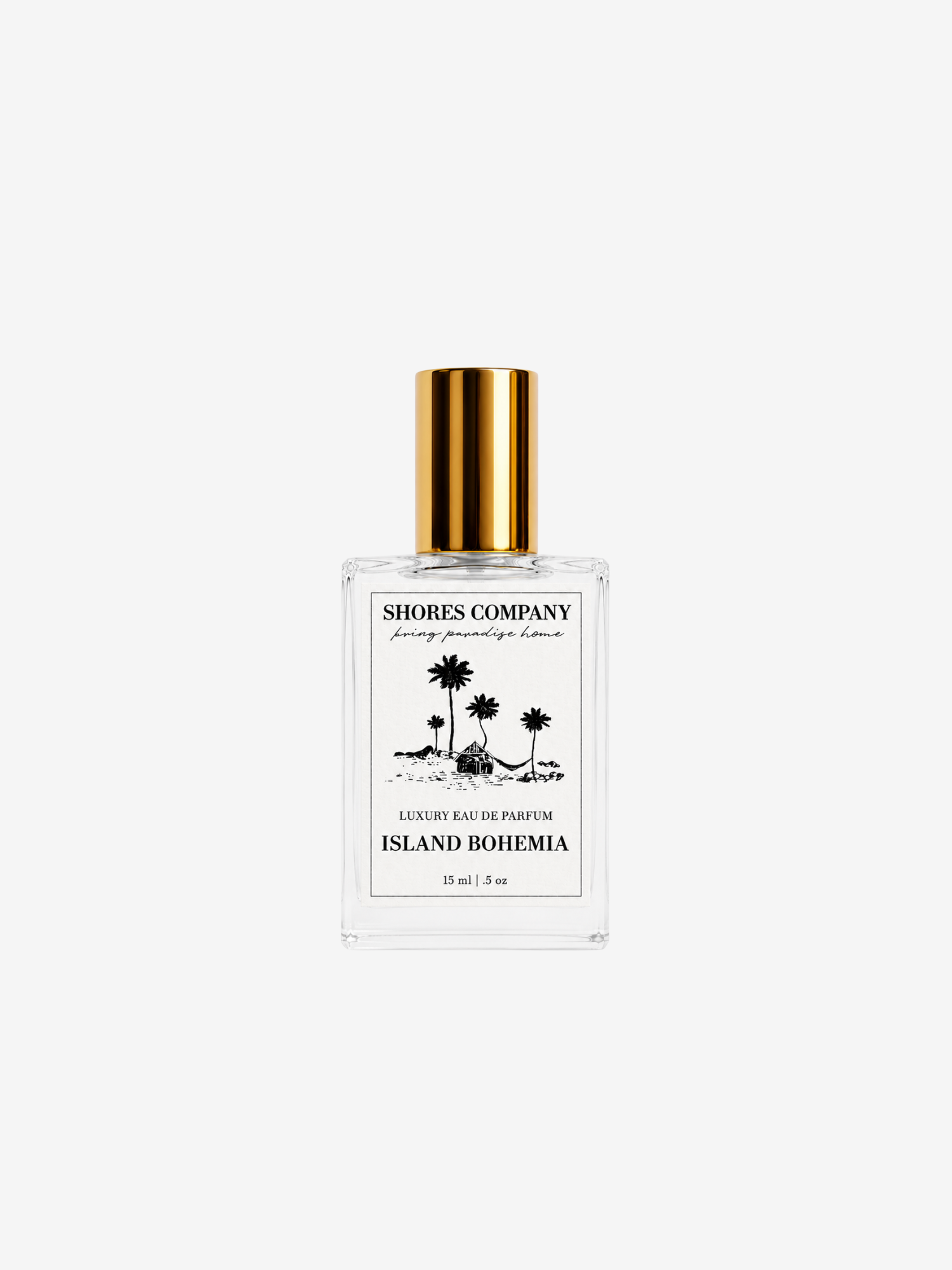 A clear glass perfume bottle with a metallic gold cap, featuring a white label with black text and palm tree illustrations. The brand 'Shores Company' is clearly visible on the label.