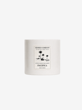 A white ceramic candle jar with a minimalist black label from Shores Company, featuring a palm tree illustration and the scent name Pacifica, set against a solid white background.
