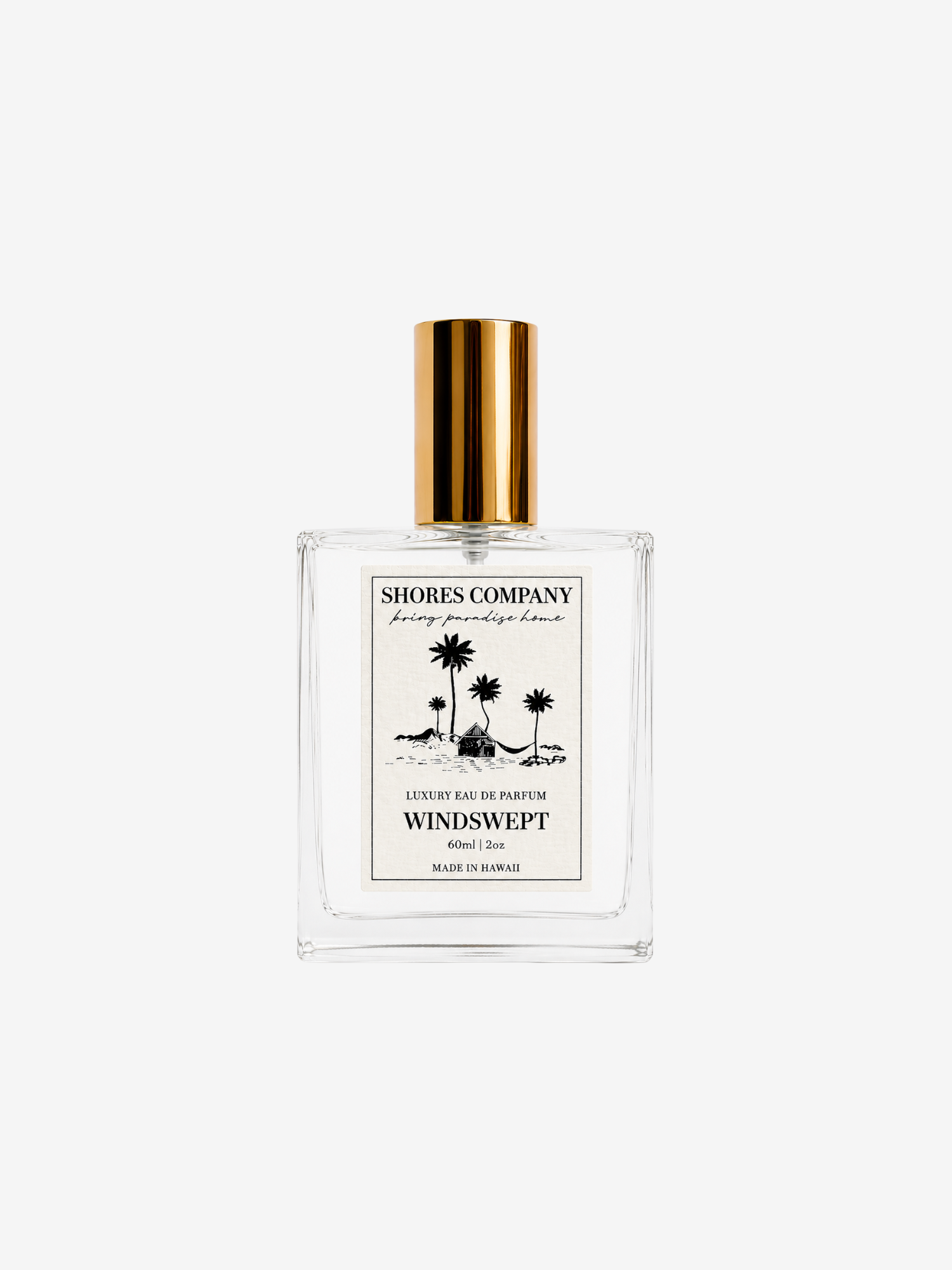 Shores Company Windswept perfume bottle with a clear glass body, white label with black palm tree illustration, and a shiny gold cap, centered on a light gray background.